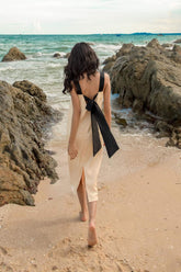 Sleeveless silk midi dress with contrast straps and back bow detail for elegant styling